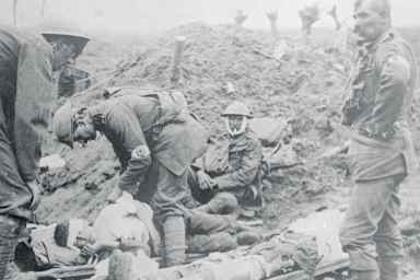 Medics helping the wounded onto stretchers, World War I.