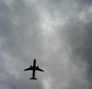 Plane Flies Overhead Against a Moody Sky Backdrop