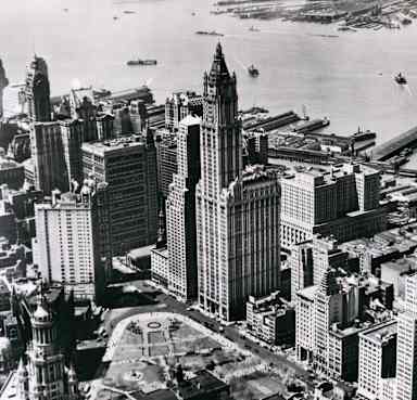 Aerial view, looking southwest, of lower Manhattan and the Woolworth Building (architect Cass Gilbert), New York, New York, April 1953. Also visible are the Singer Building (architect Ernest Flagg) (spire at rear left), City Hall (bottom, center), and City Hall Park. (Photo by Underwood Archives/Getty Images)