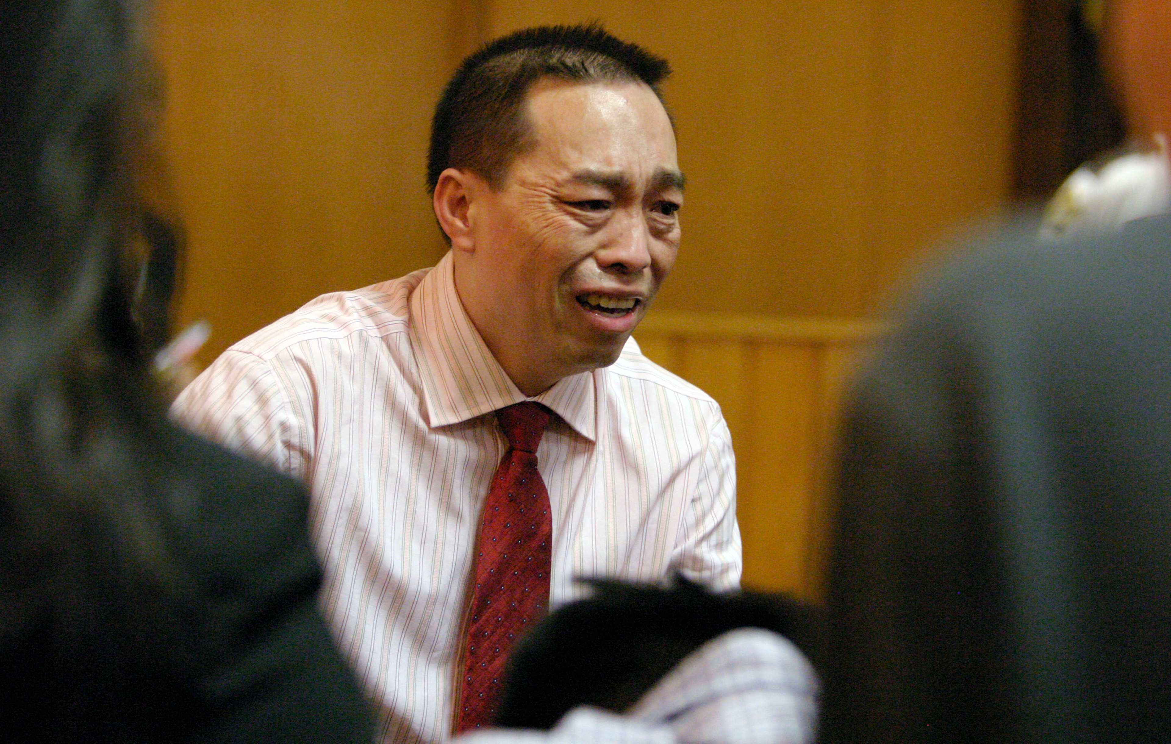 Chai Soua Vang reacts as he looks back to his family after testifying at his murder trial, Thursday, Sept. 15, 2005, in Hayward, Wis. Vang is charged with six counts of first-degree murder and two counts of attempted murder in the Nov. 21, 2004 shootings