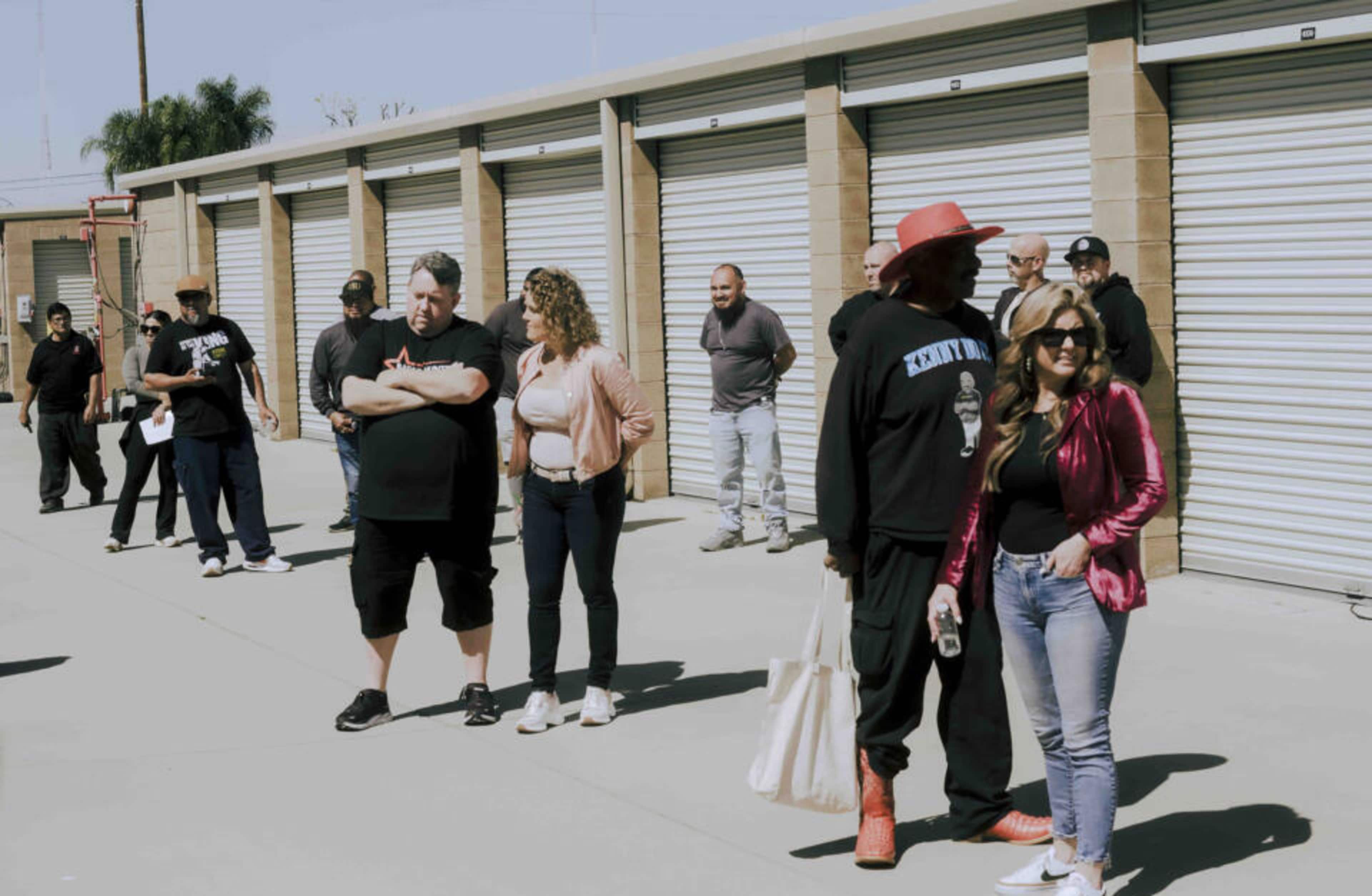 Brandi Passante and her fellow storage unit bidders wait for an auction to kick off.