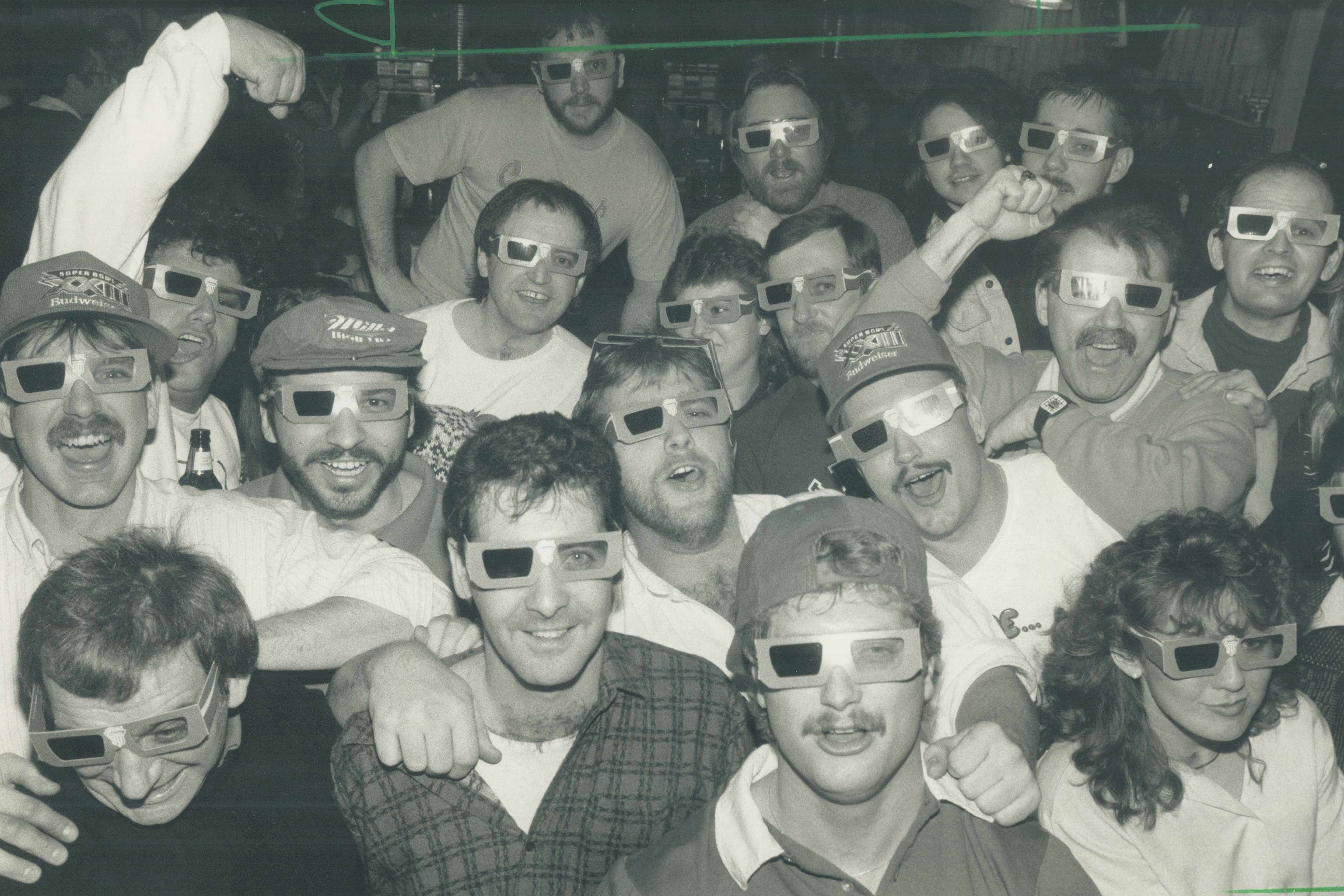Super Bowl fans party in Metro as they watch the half-time through 3-D glasses. Most at K. C. McFly's tavern on Victoria Park Ave. yesterday backed the 49ers and went wild at the last-minute 20-16 win over the Bengals. (Photo by Colin McConnell/Toronto Star via Getty Images