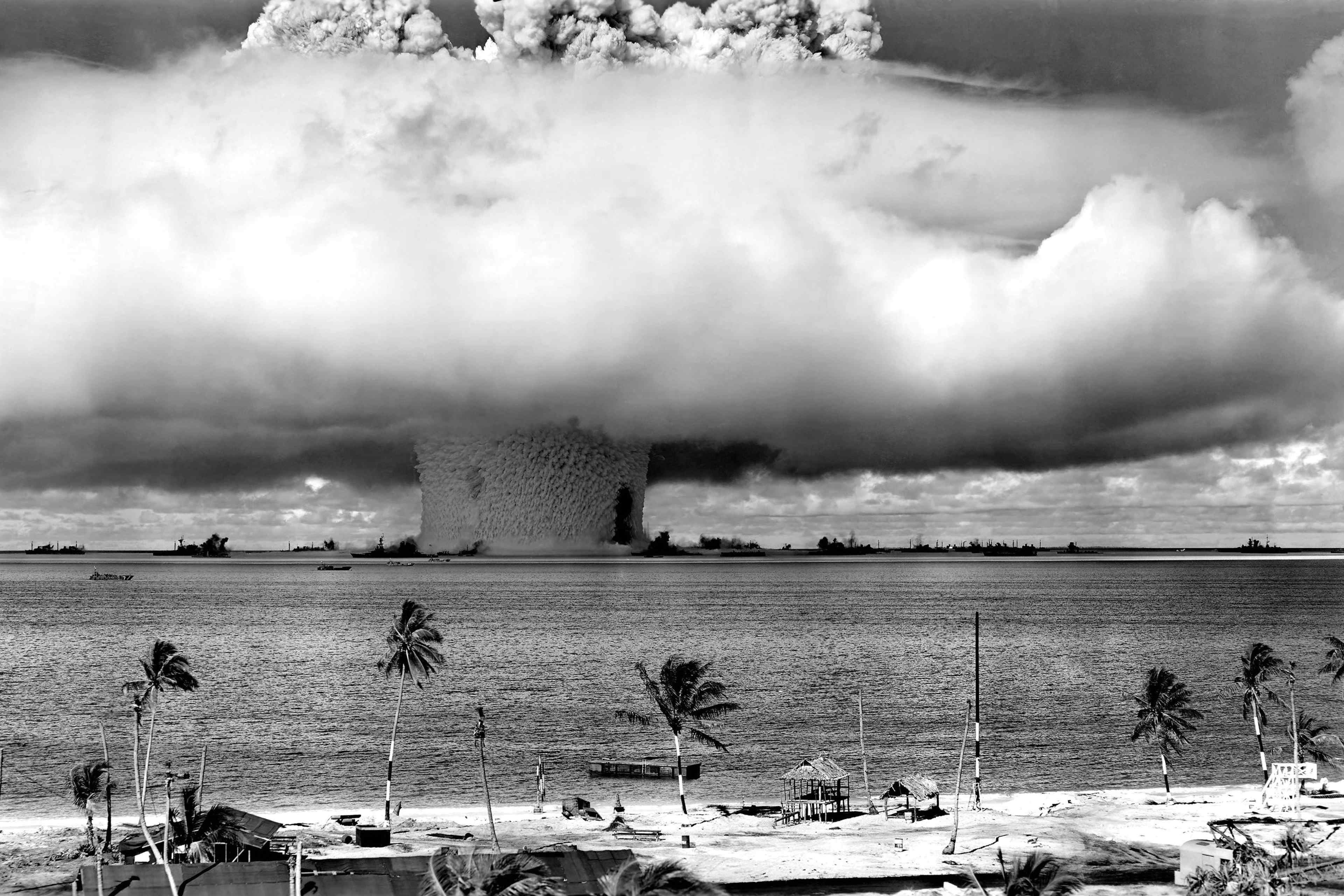 huge mushroom cloud exploding over a tropical island