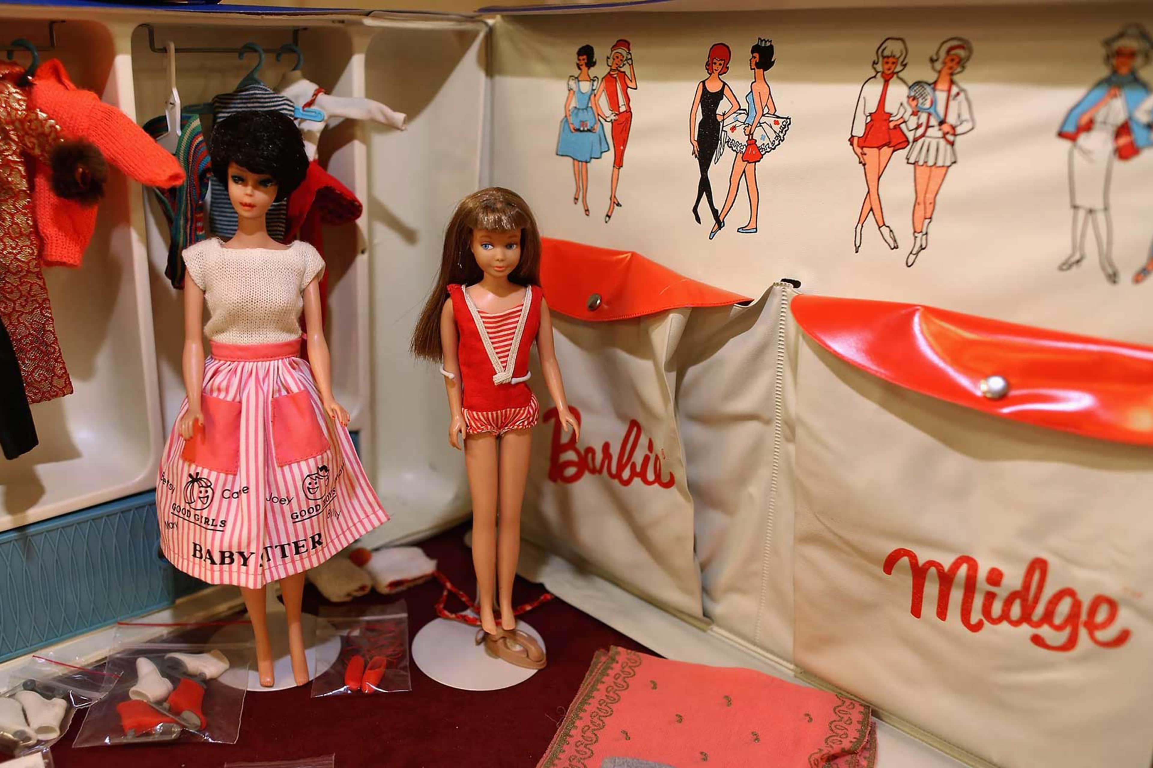 A vintage Barbie and Midge with carrying case.