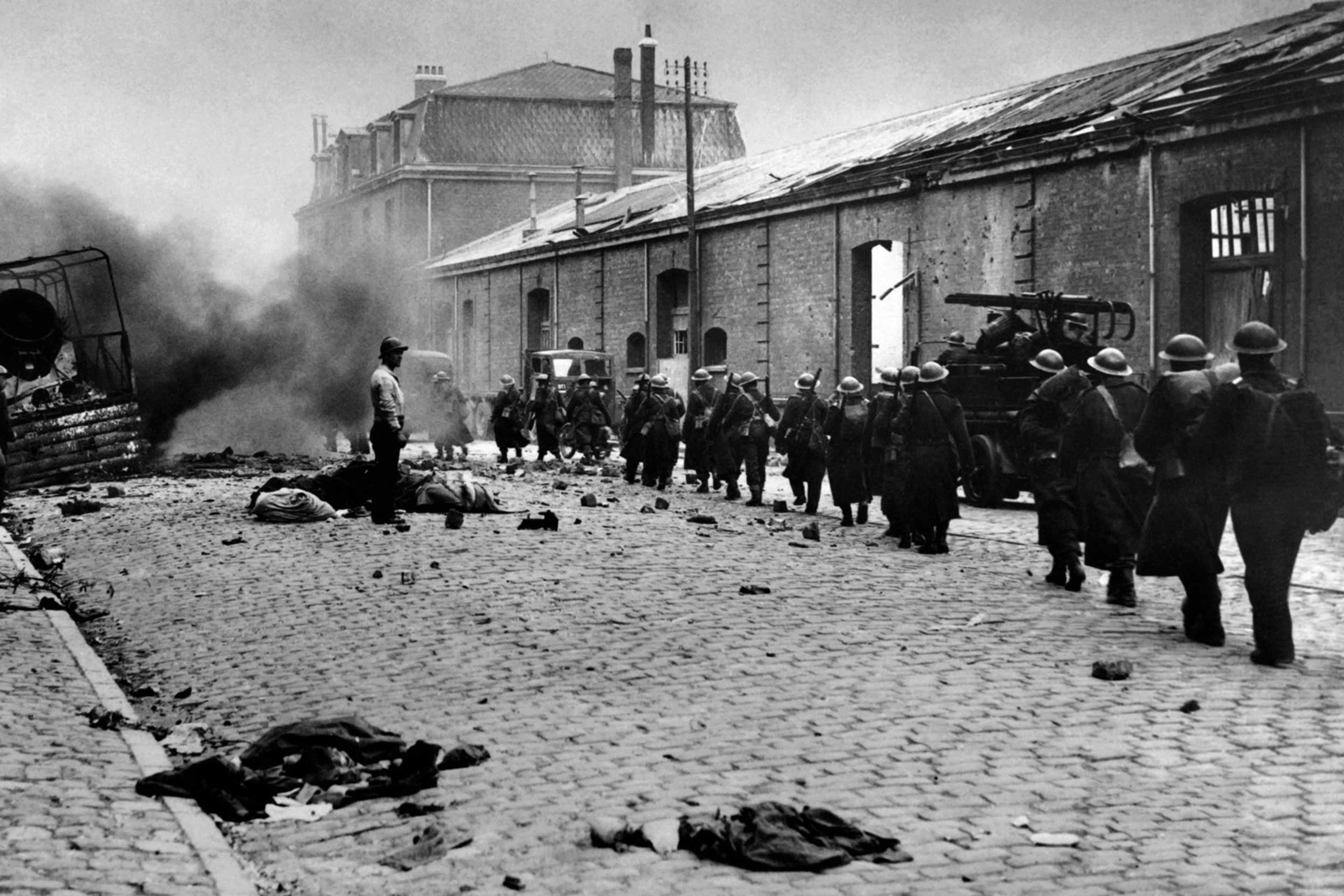 FRANCE-WAR-ARMY-BATTLE Undated picture of troops crossing the mids of debris of the rubble-strewn streets in Dunkerque, France, during the 2nd World war. (Photo by - / AFP) (Photo credit should read -/AFP via Getty Images)