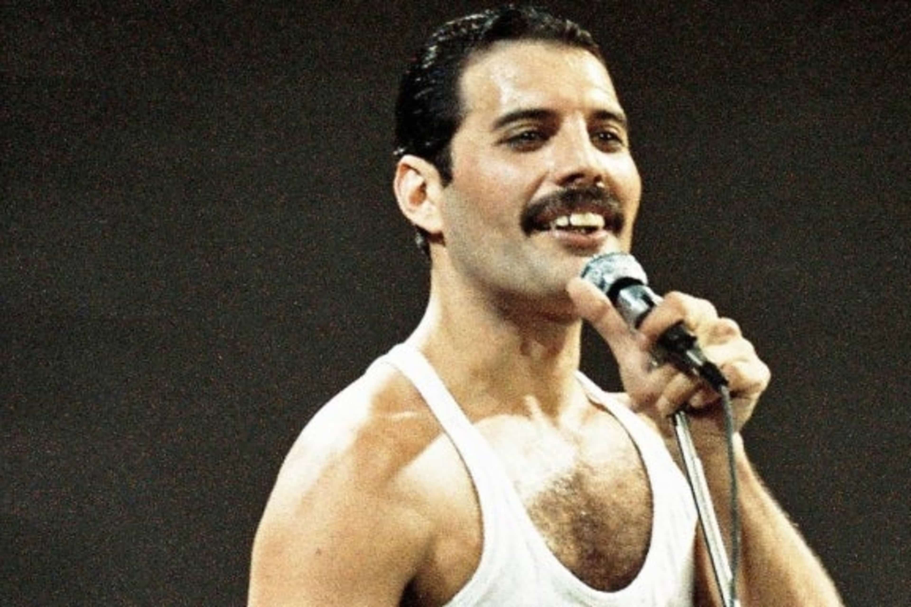 Freddie Mercury of Queen performs on stage at Live Aid on July 13th, 1985.