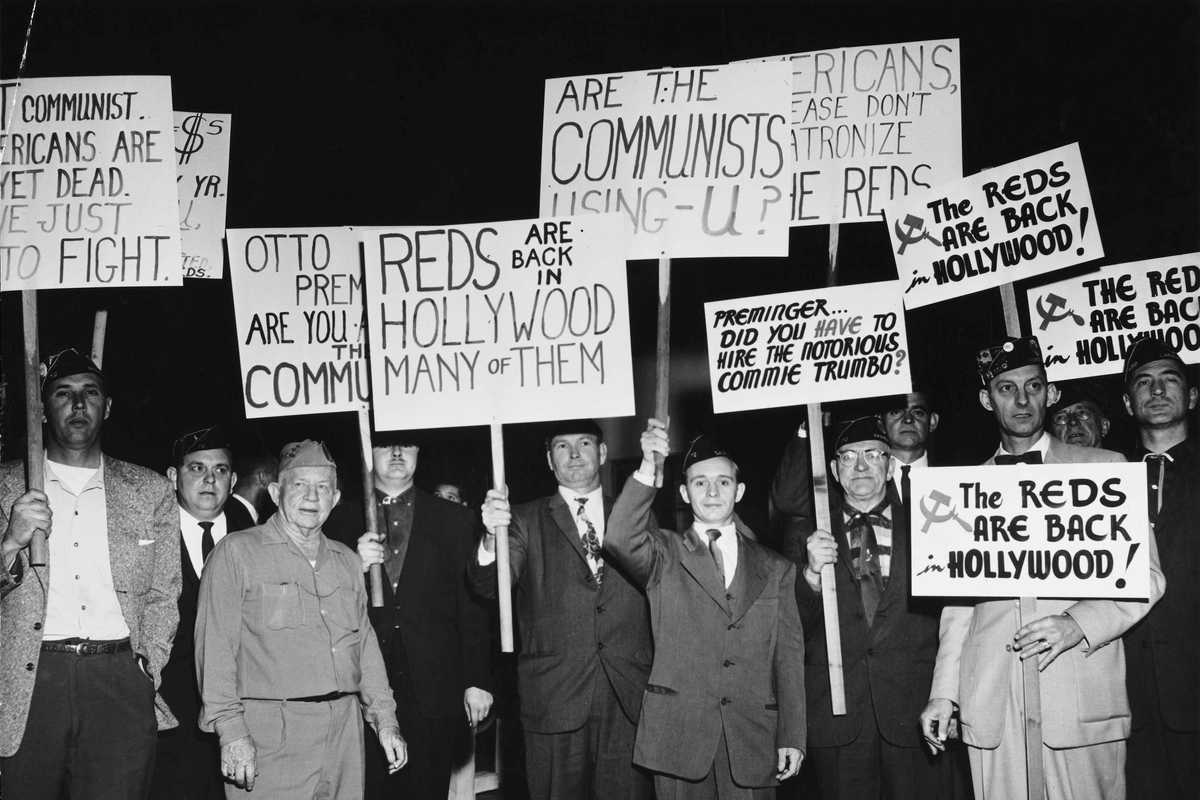 A group of protesters demonstrate holding placards against Communist sympathizers outside the Fox Wilshire Theatre in occasion of the premiere of film 'Exodus', which marked the end of the 'Hollywood Blacklist' when screen player Dalton Trumbo, a Communist Party member from 1943 to 1948 and member of the Hollywood Ten, was credited as the screenwriter of the film, Beverly Hills, Los Angeles, California, US, December 1960. (Photo by American Stock Archive/Archive Photos/Getty Images)