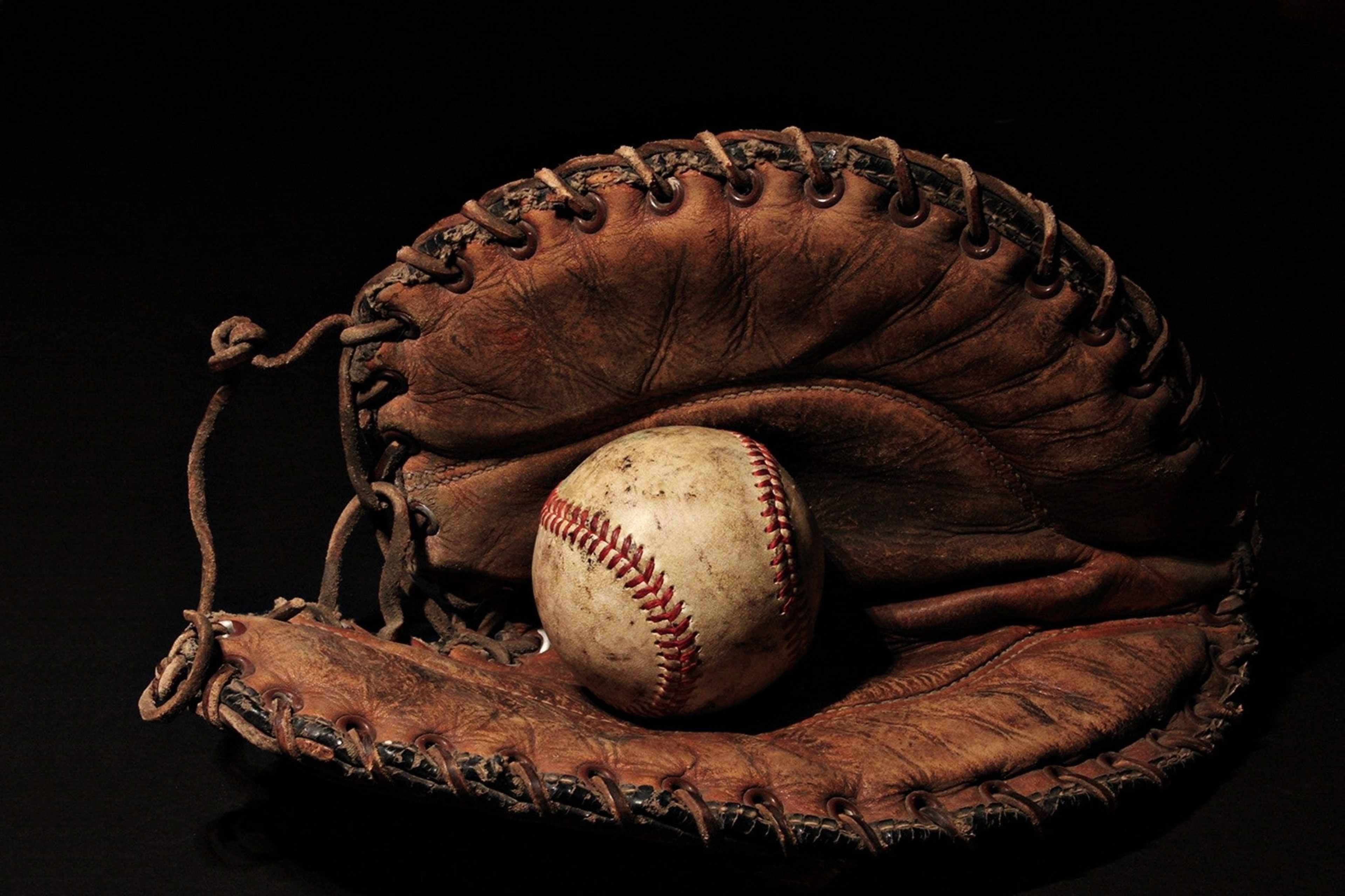 A baseball in a baseball mitt.