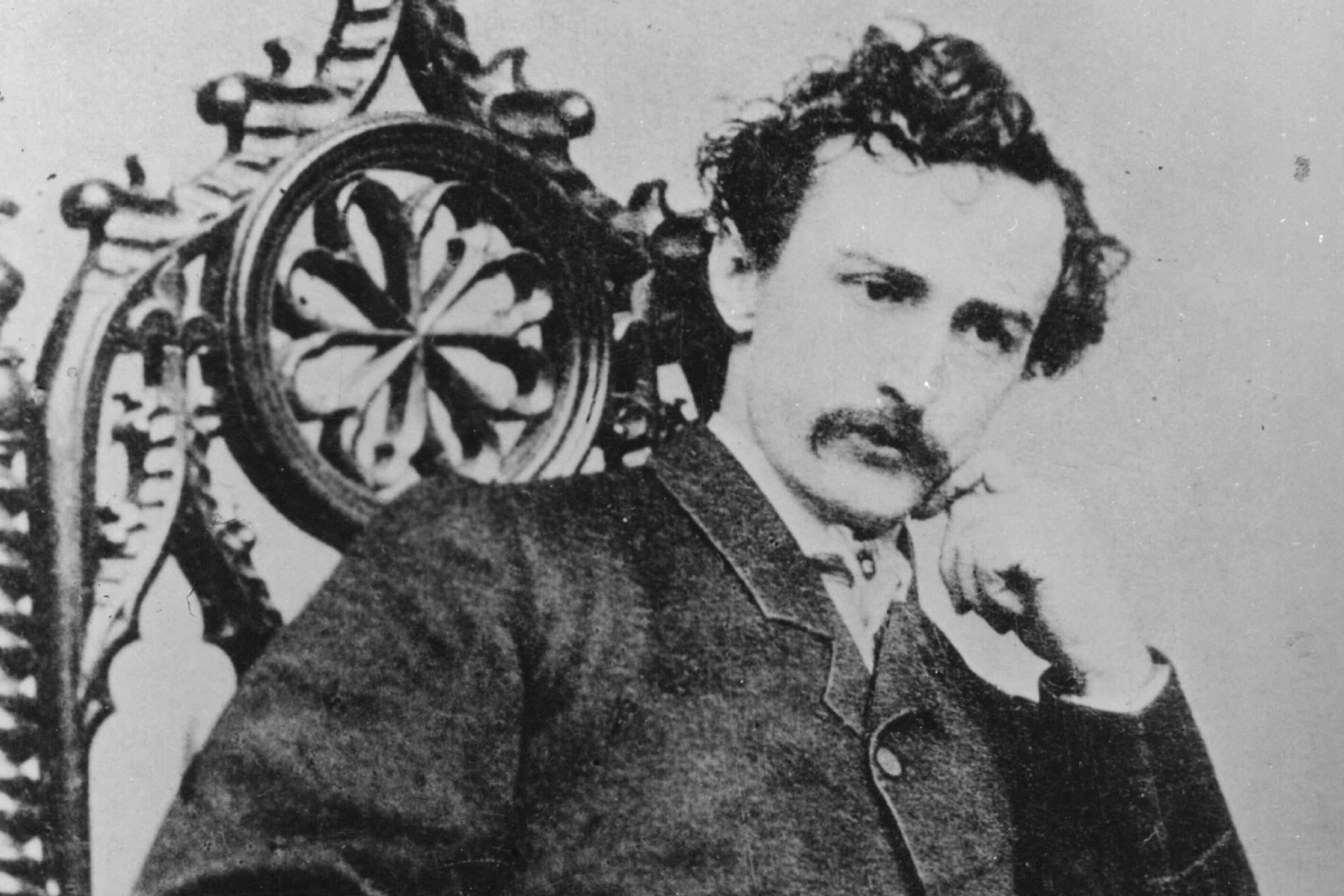Seated portrait of John Wilkes Booth with his hand under his chin