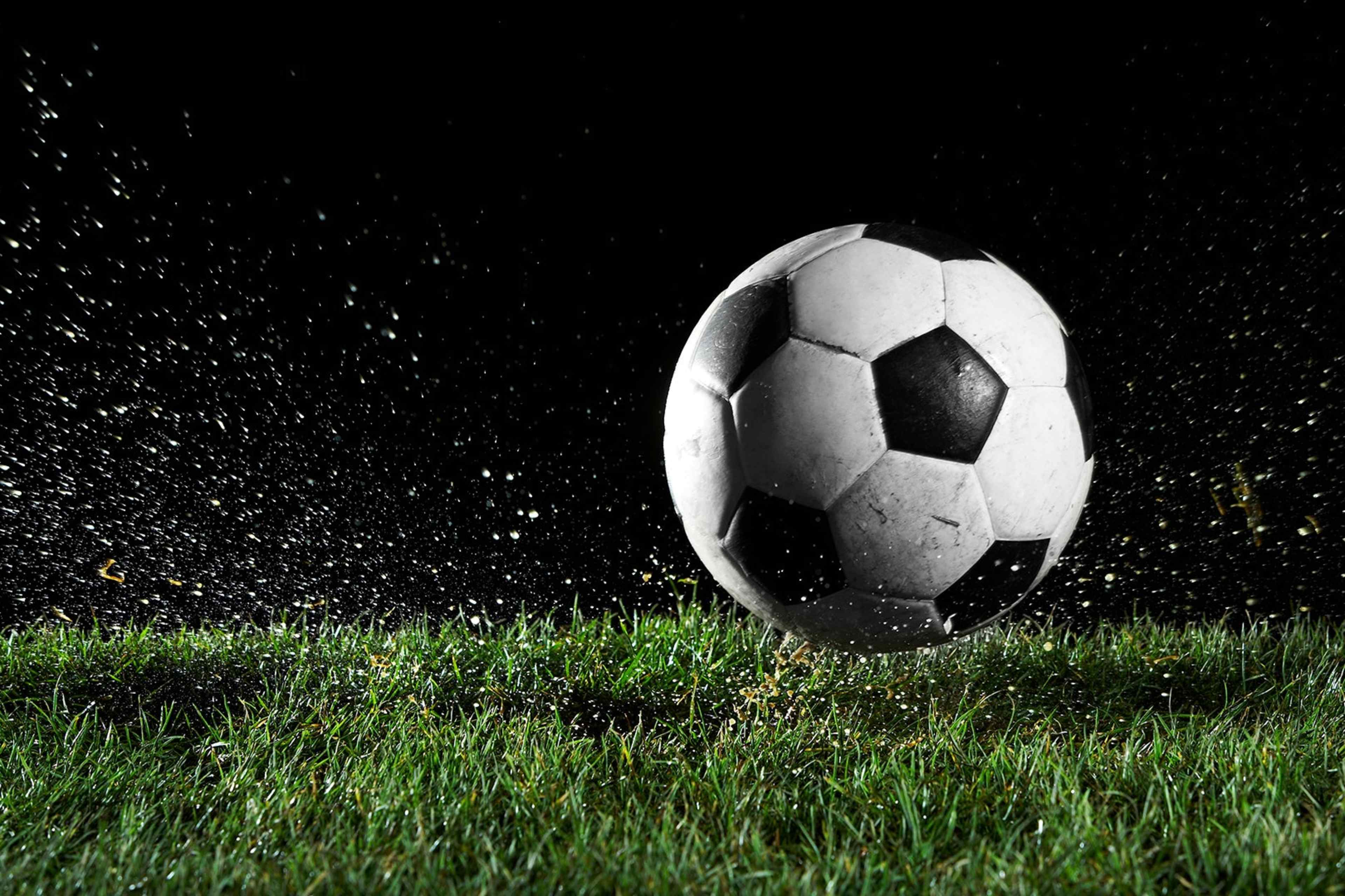 A soccer ball in motion over grass.