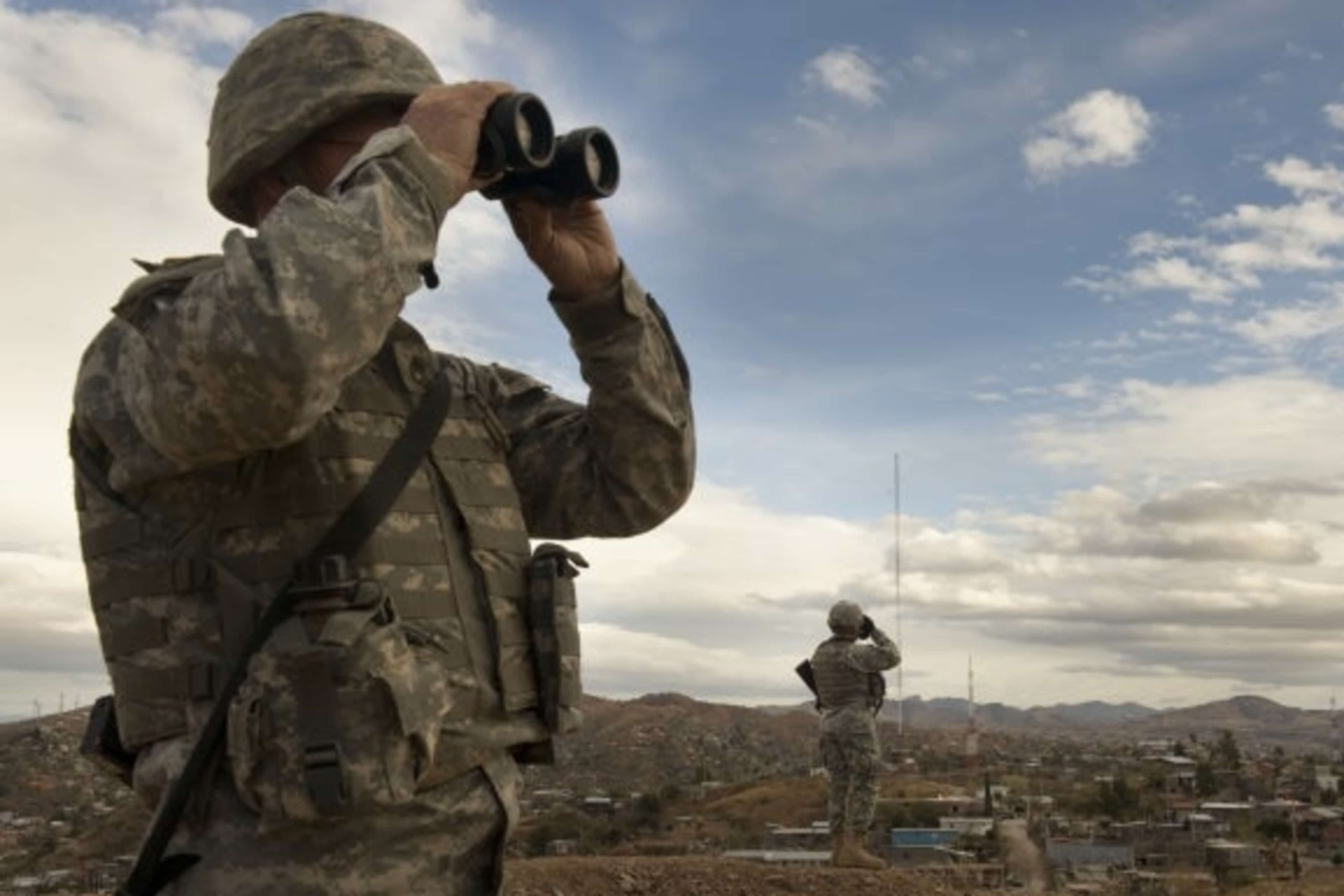 Members of the US Army National Guard keep watch along the US Mexico border in Nogales, Arizona, 2010. (Credit: Nikki Kahn/The Washington Post via Getty Images)