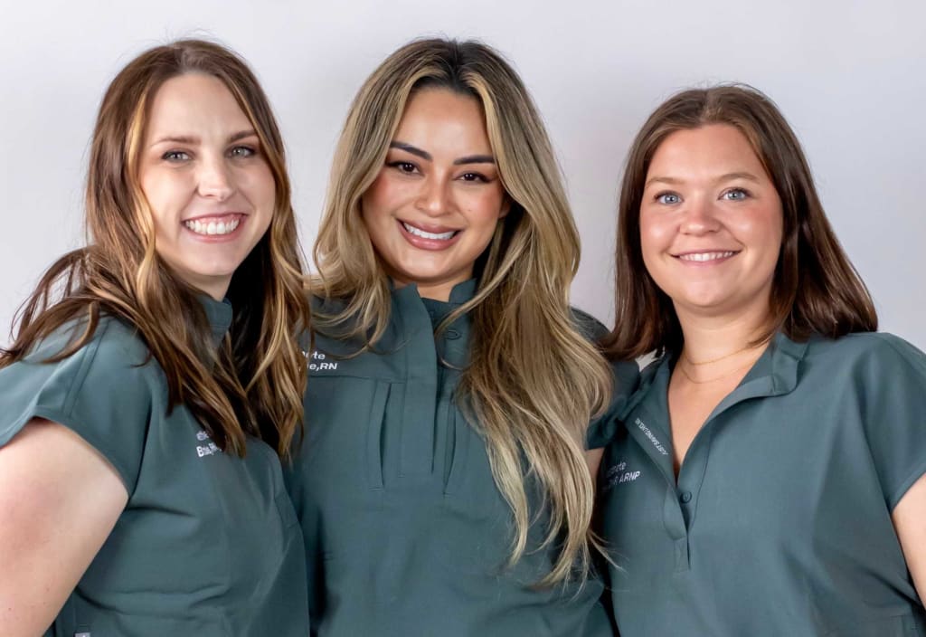 three nurses smiling at the camera