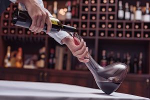 A sommelier decanting wine