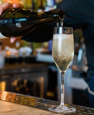 Champagne being poured into a glass with a lot of bubbles