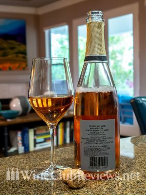 Michel Sarrazin, Crémant de Bourgogne Rosé NV Back of bottle with glass of wine