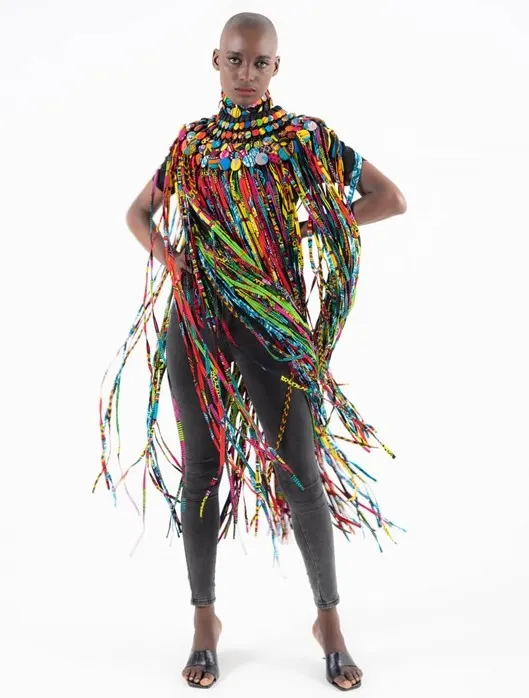 Model wearing Aphia Sakyi neckpiece. The button and fringed printed fabric neckpiece is an ideal accessory if you are thinking of festival outfit ideas. Made in Ghana.