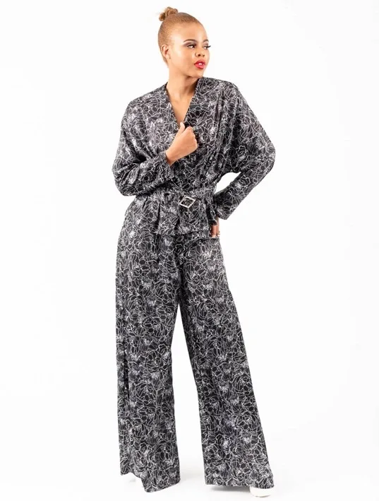 Belted black satin two piece with white graphic prints. The top and pants are available for purchase as separates.