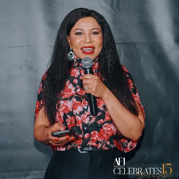 oburg Fashion Week - A collage of an African woman at a party. The woman is wearing a printed blouse with a pair of trousers and is standing on a red carpet with a black backdrop.