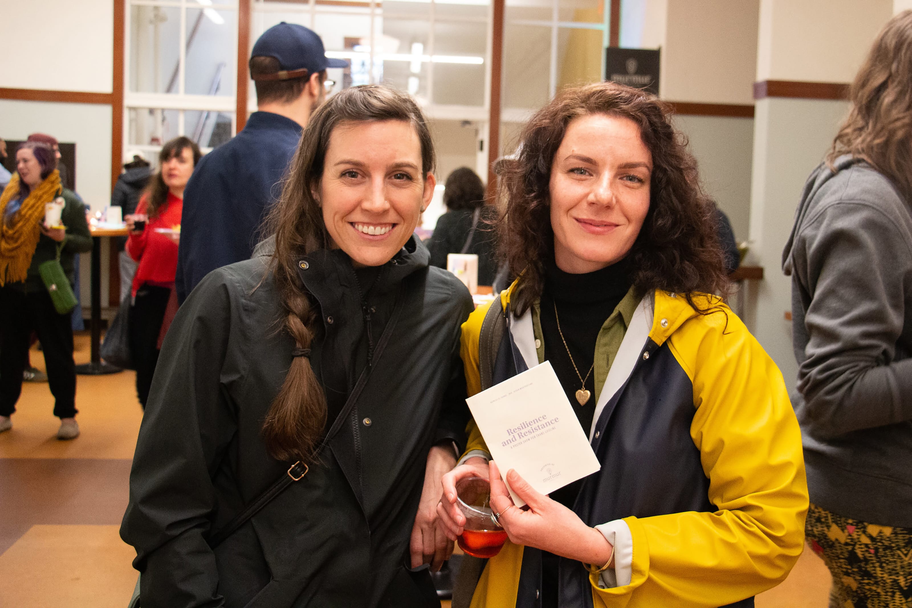 Two people holding program literature