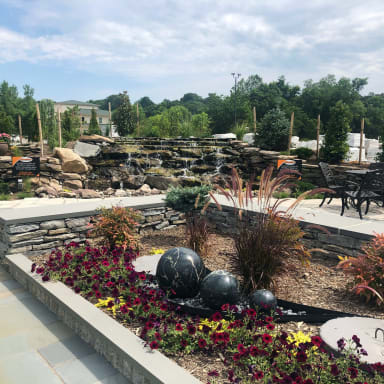 Our stone garden features a variety of outdoor displays, including waterfalls, retaining walls, and garden setups.