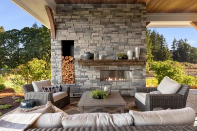 Fall outdoor living space with fireplace, seating and outdoor kitchen