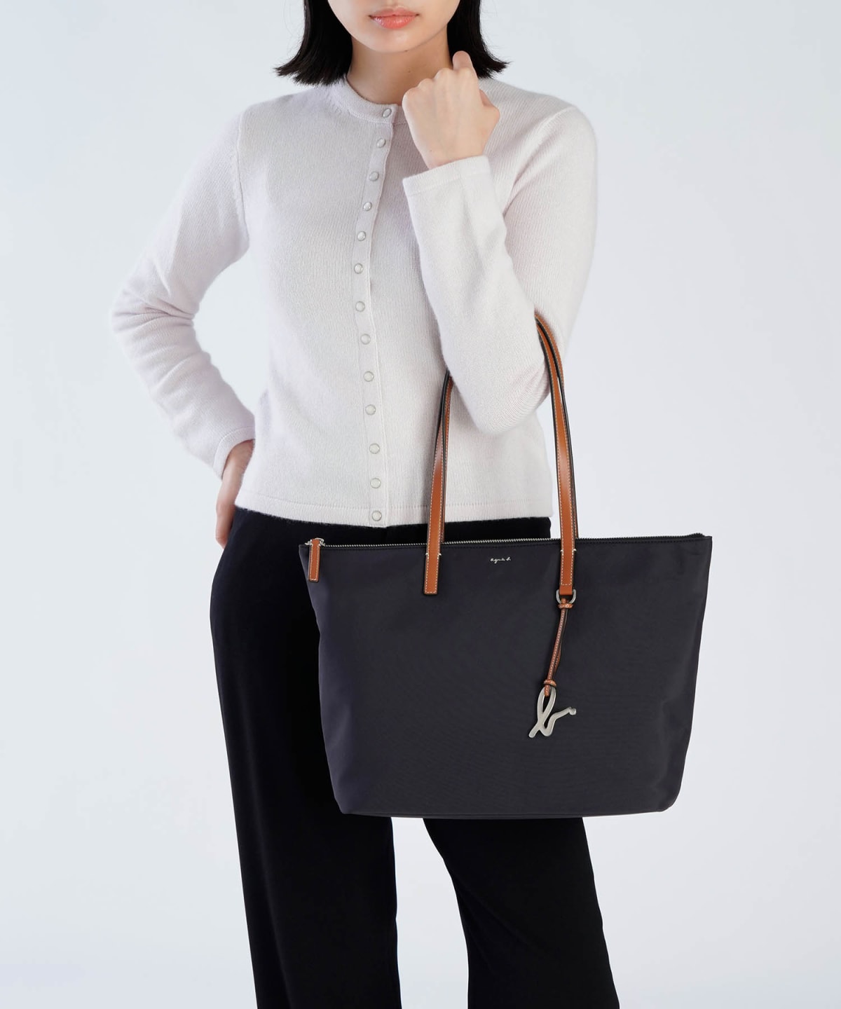 black nylon bag with brown handles