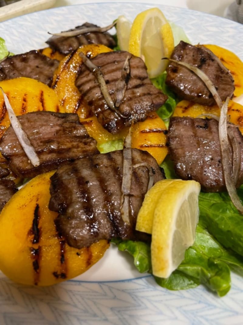 Grilled ox tongue gyutan with grilled peach and lemon wedges