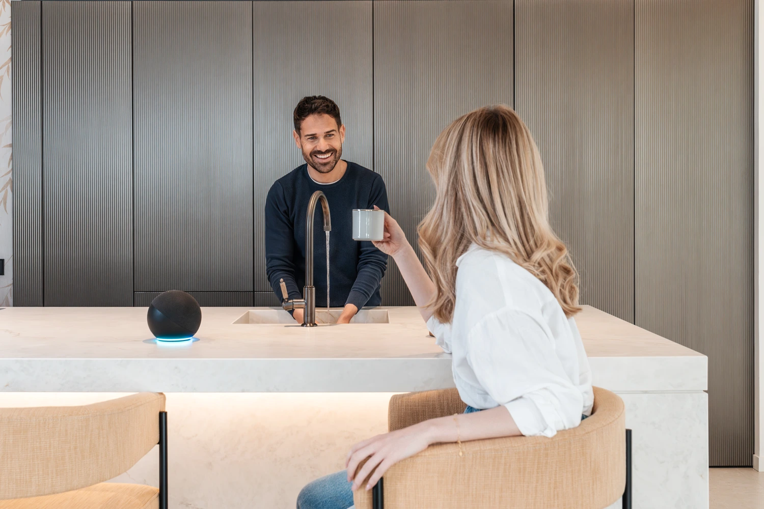 Couple chatting animatedly in the kitchen