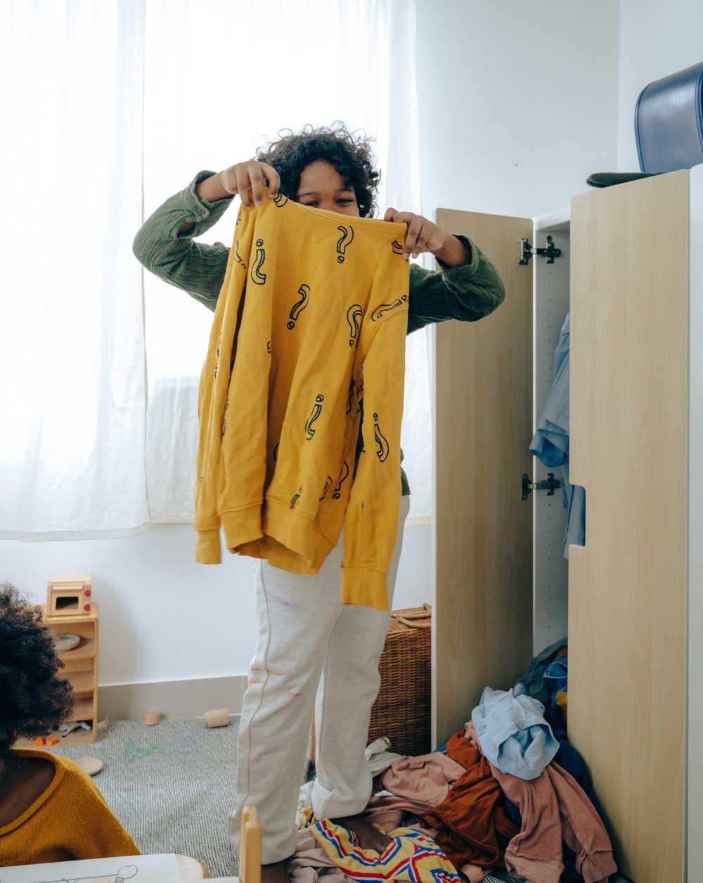 Teenage boy cleaning his bedroom.