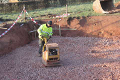 Main compresses stones using a machine.