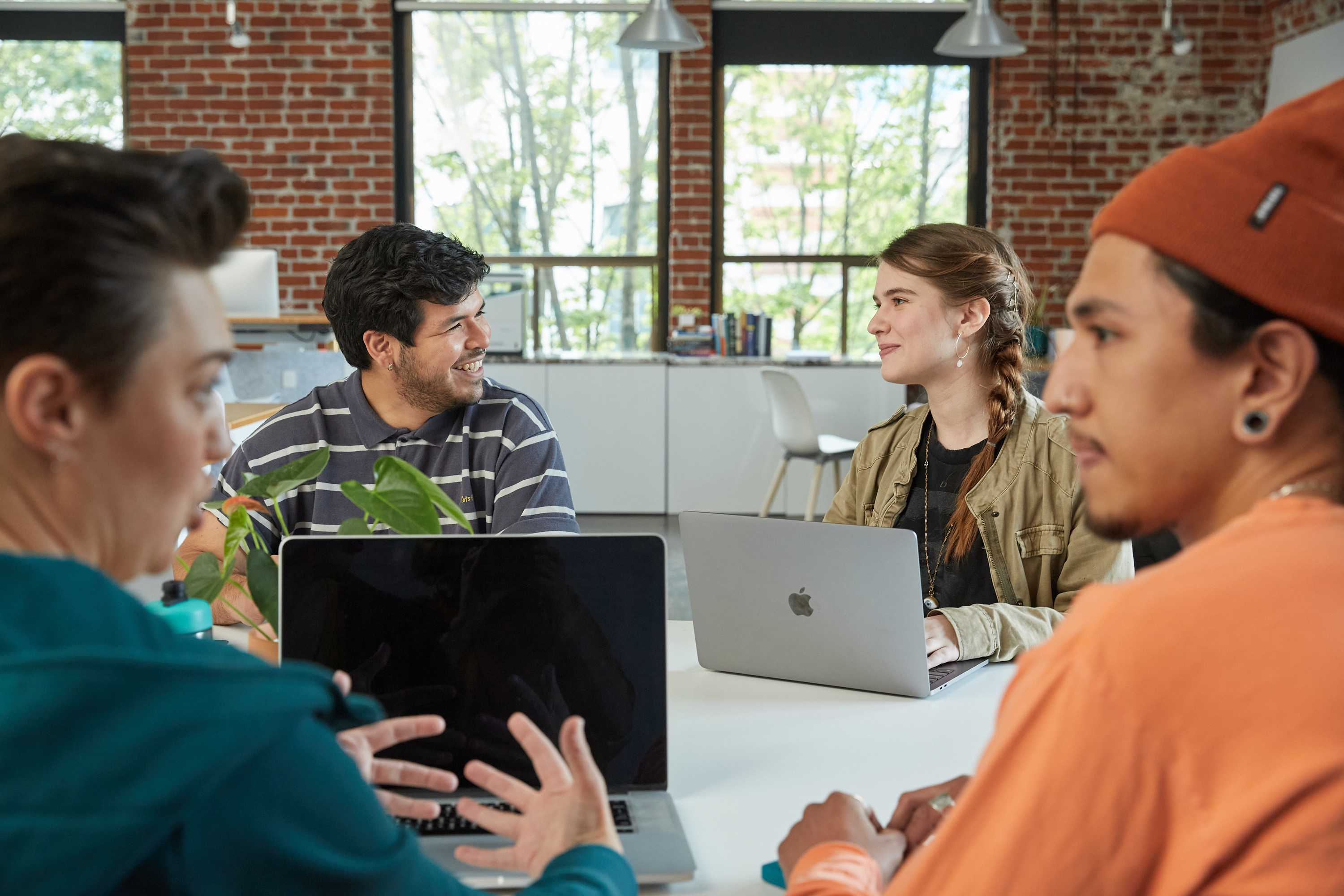 Four coding students gathered around a table