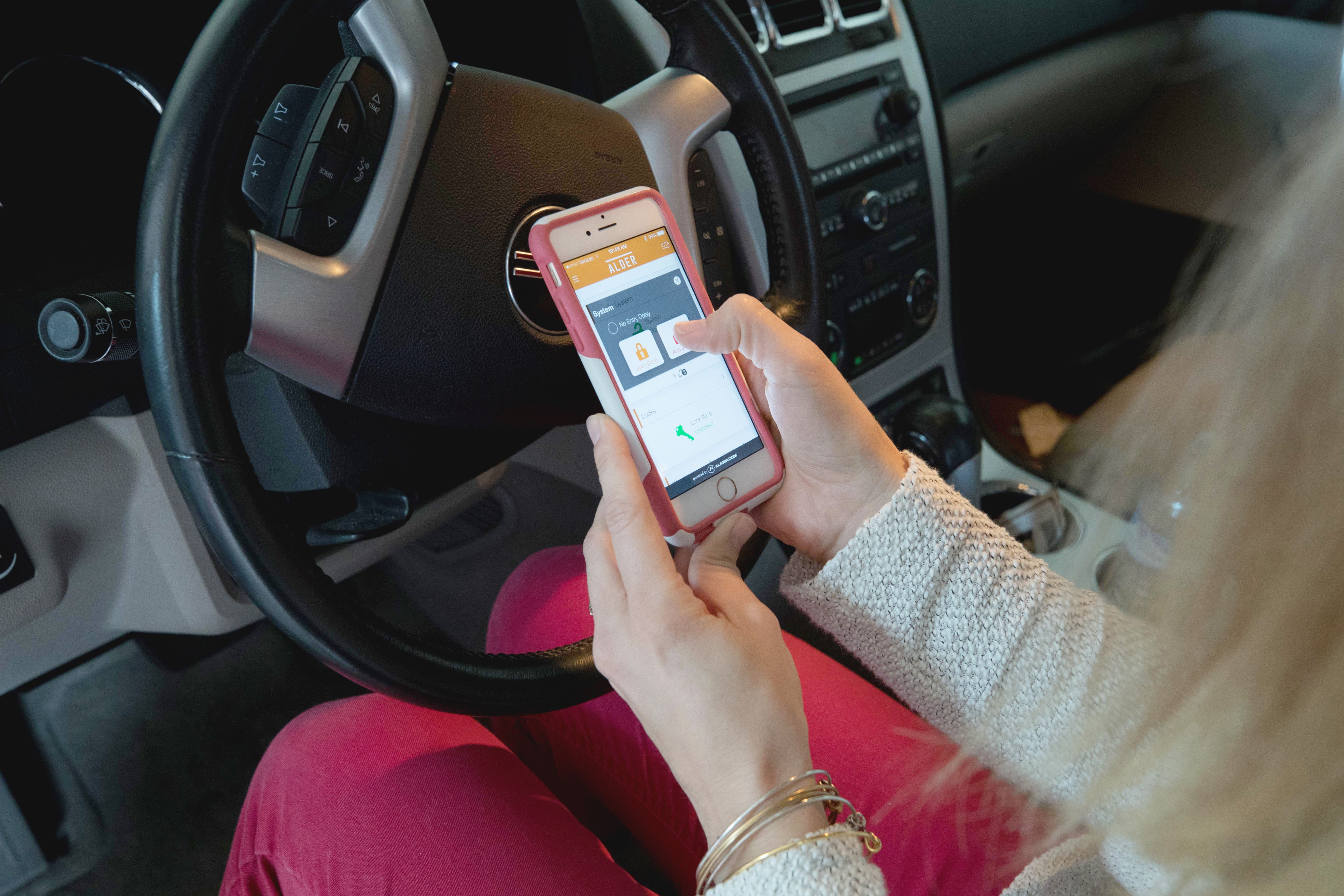 someone in the car using the alder security app