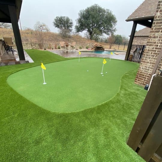 Poolside putting green on turf in DFW