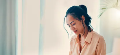 Woman creating a moving budget in a notebook