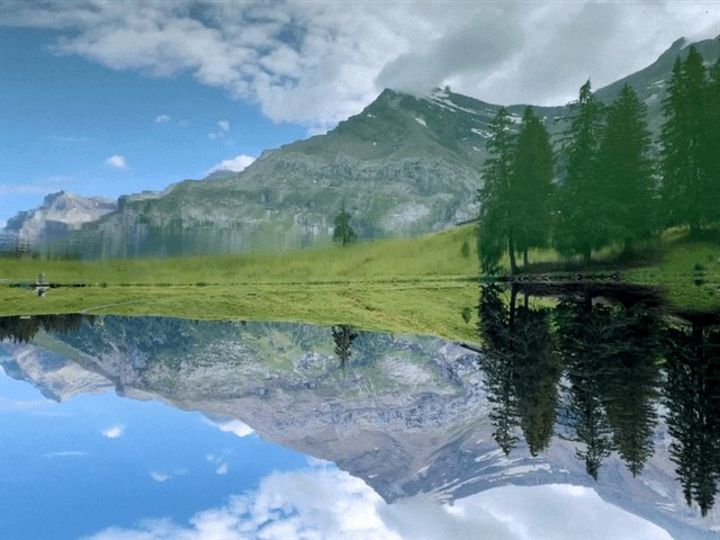 Lac Retaud in the front and the mountain with the Glacier des Diablerets in the back. The picture is upside down so the the reflexion in the lac looks like being the sky