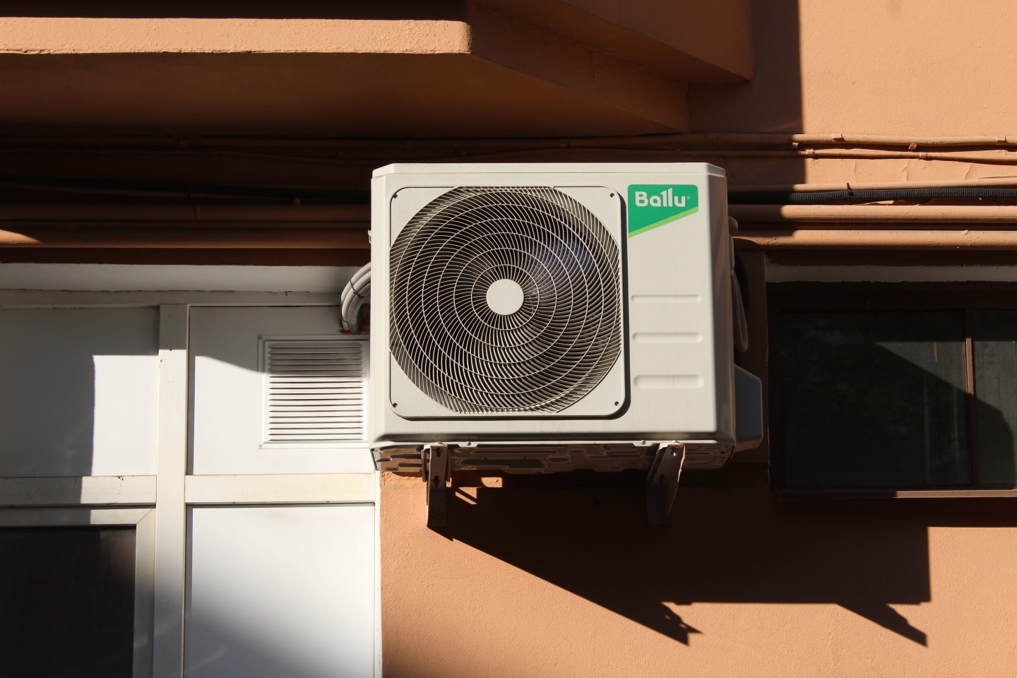 Modern air-conditioning condenser unit mounted outside a home