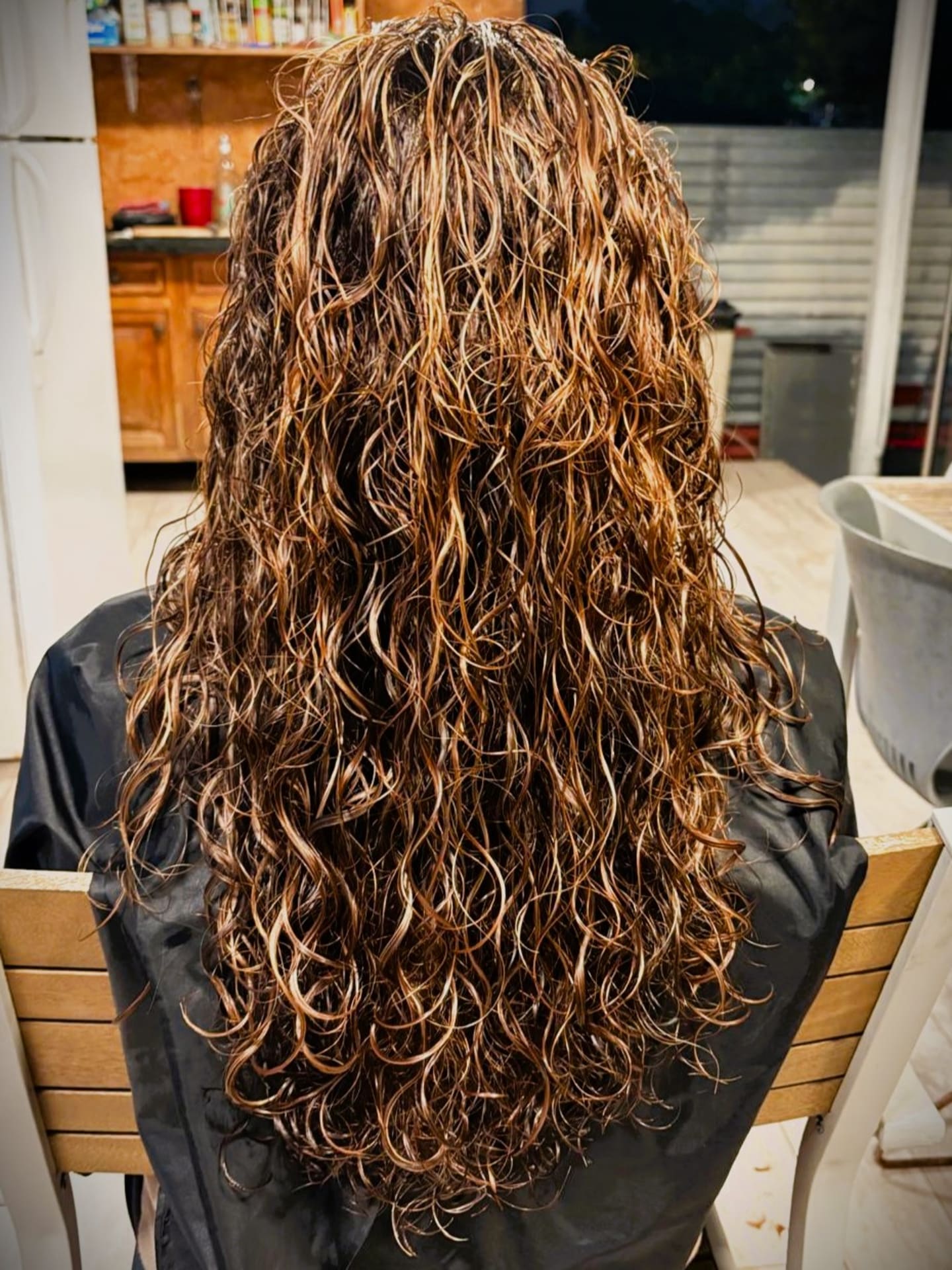 Long brunette hair styled in glossy, voluminous waves