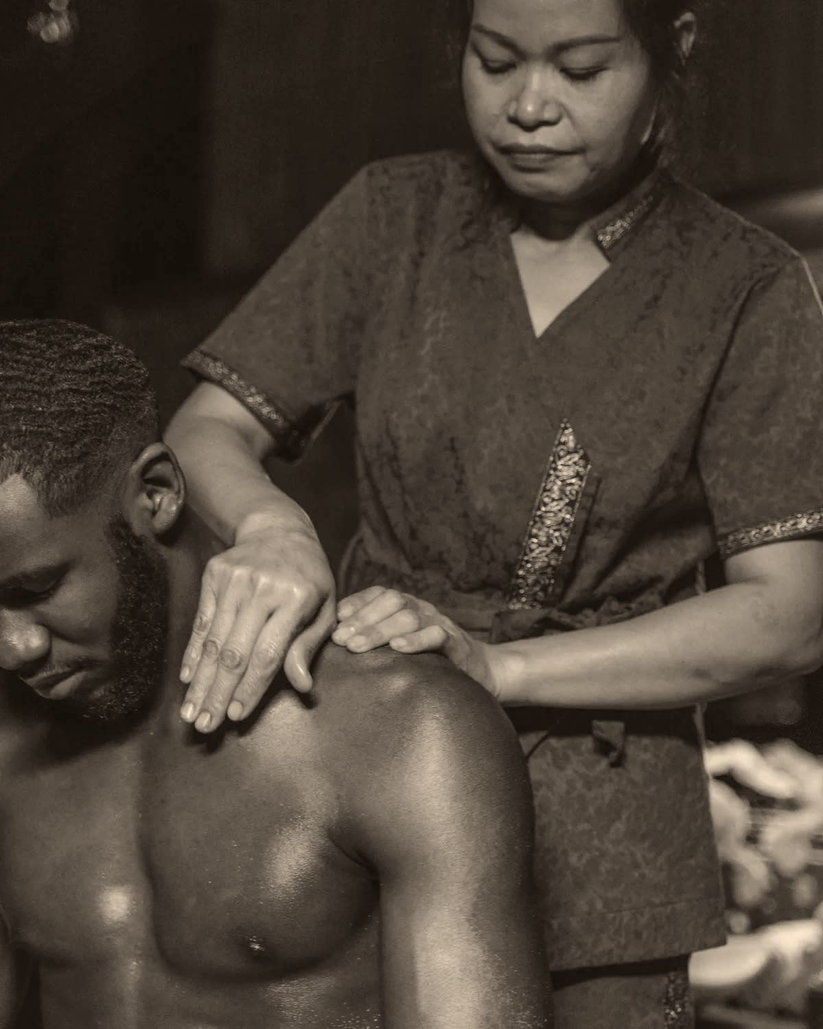 A practitioner working deep into a client’s shoulder and upper back for neck and back relief.