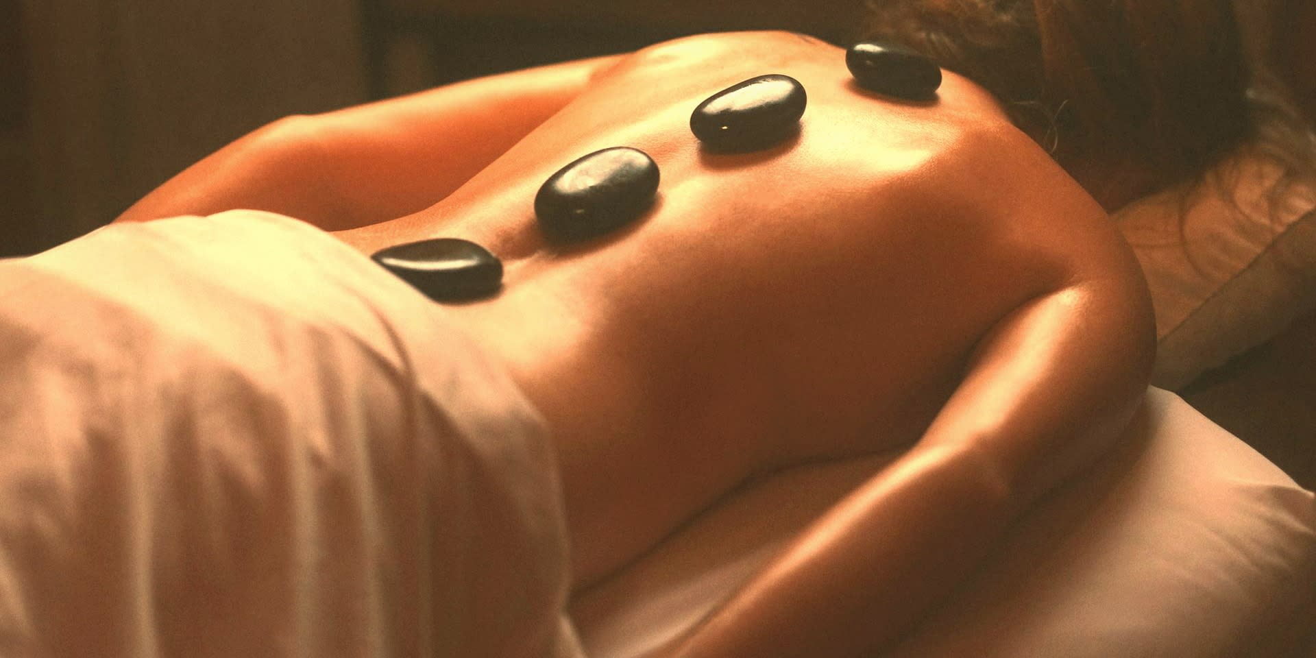 A warm, low-lit treatment room in Miami with a session in progress.