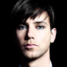 Tiga Headshot