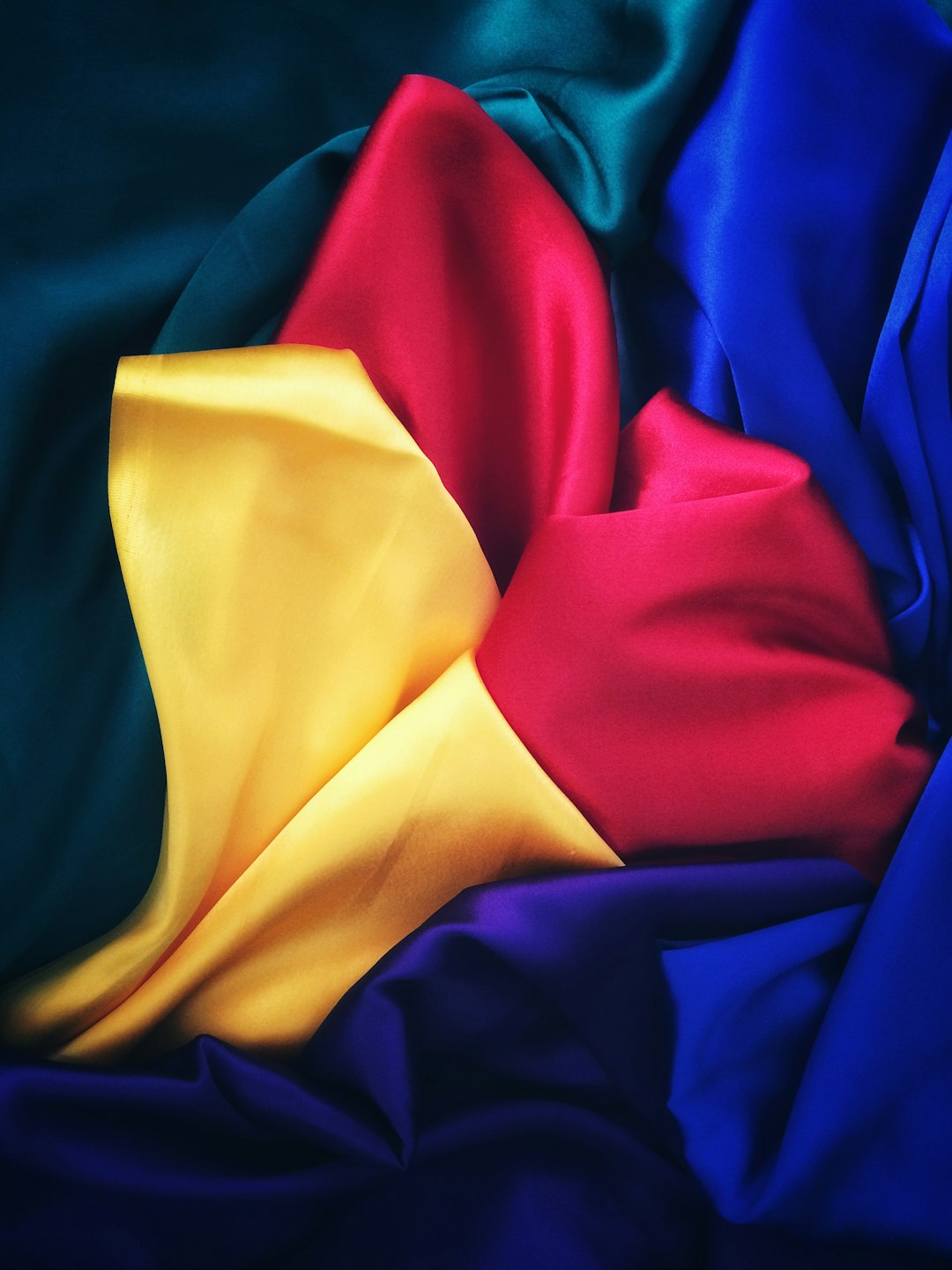 Collection of cloths in blue, red, yellow, and purple