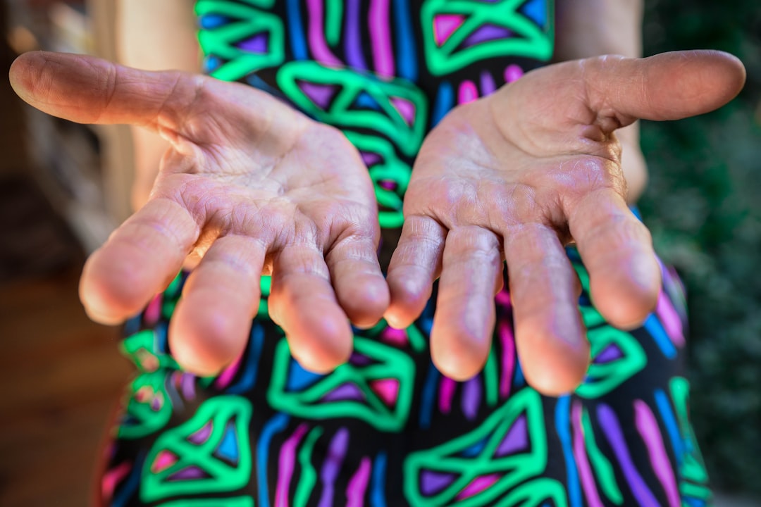 A close up of a person holding both hands, palms up to the camera