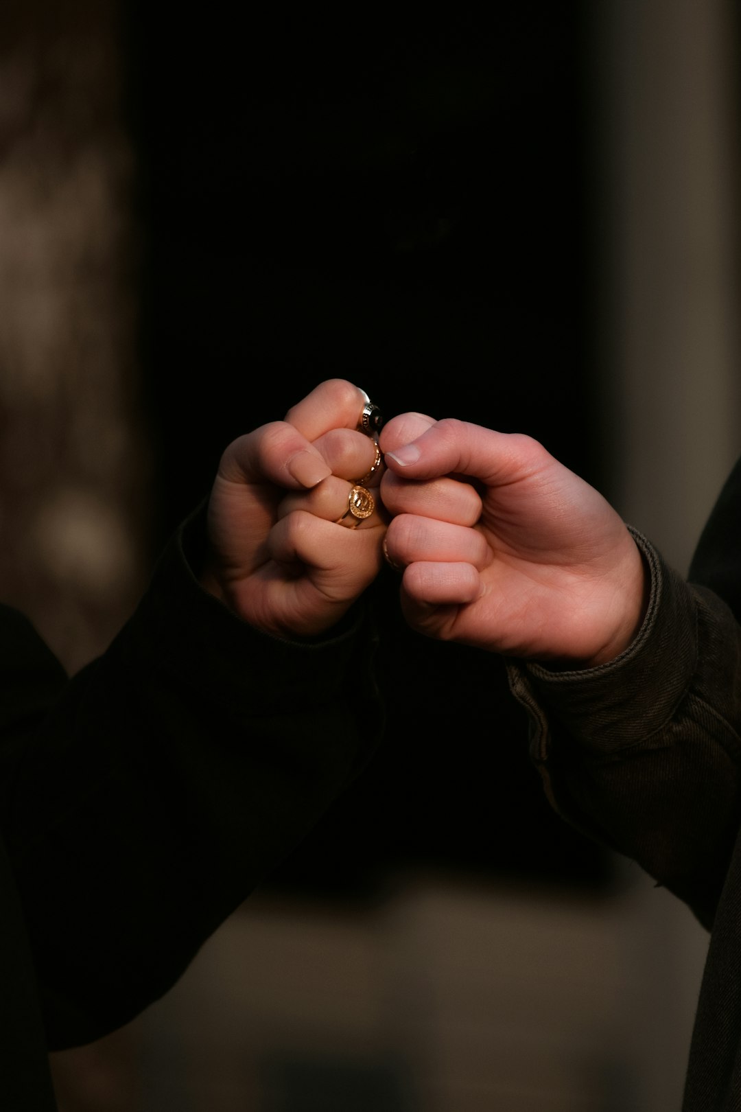 A Pic of two people giving a fist bump, showing only the fists and forearms.