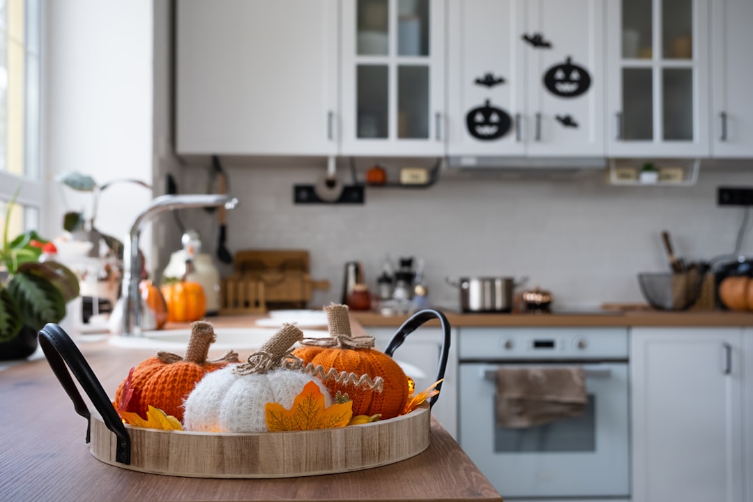yarn pumpkins sitting on a tray in a white farmhouse style modern kitchen