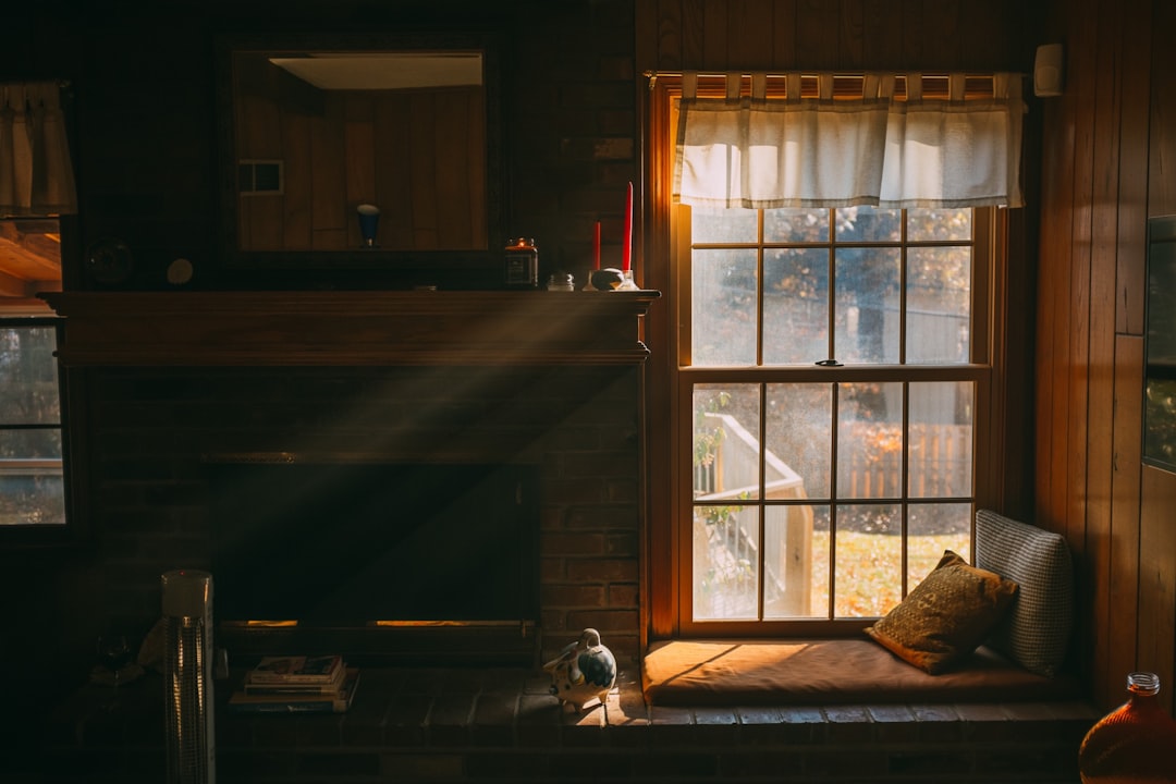 dimly lit room with sunlight coming through a window over a sitting area