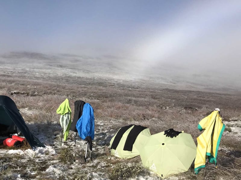 Trekking in den Drakensbergen Südafrika: Biwakplatz mit zwei Kuppelzelten und zum Trocknen gehängter Kleidung