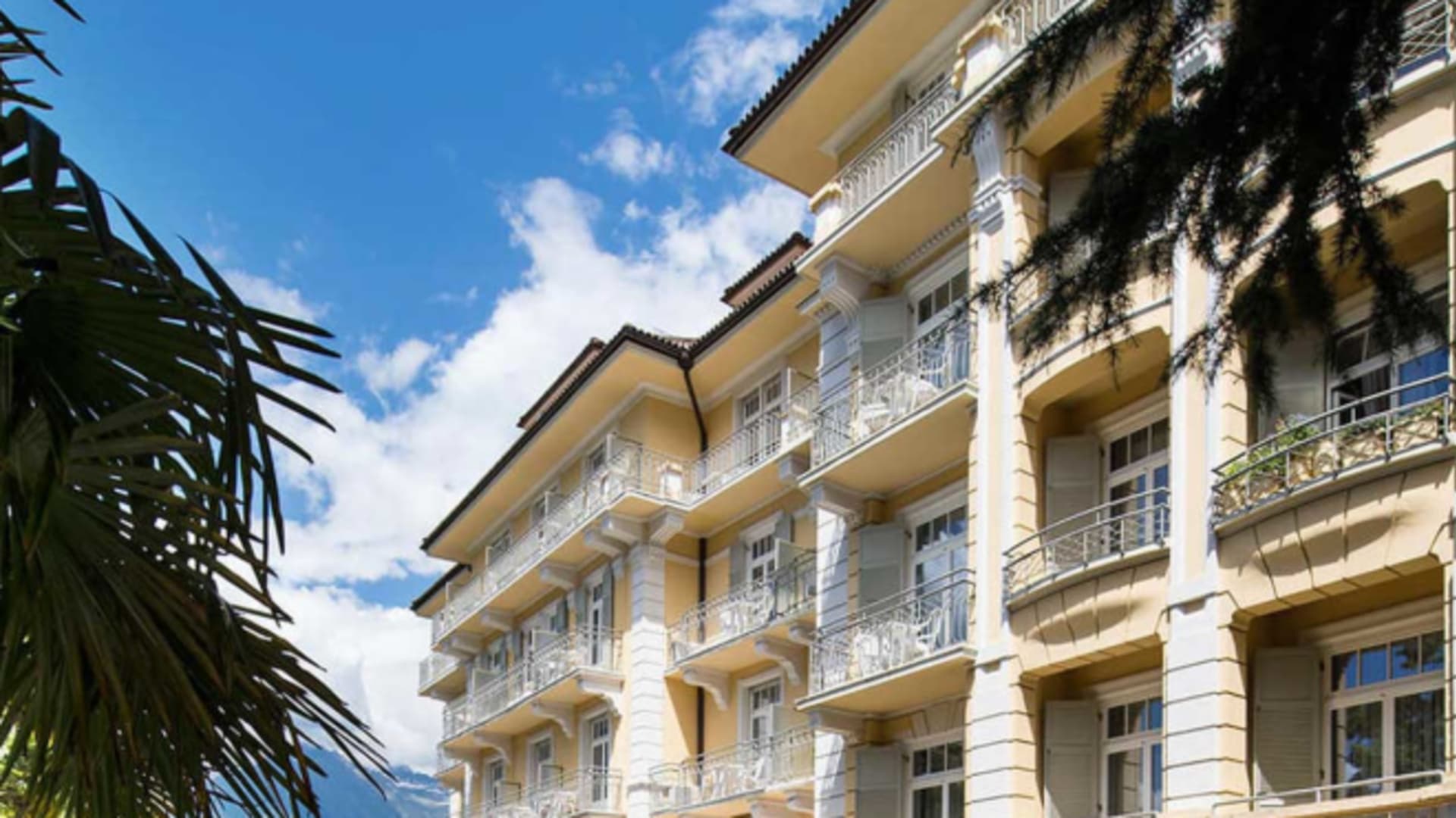 Außenansicht vom Hotel Kolping Meran mit klassischer Jugendstilfassade und Säulen im Erdgeschoss.
