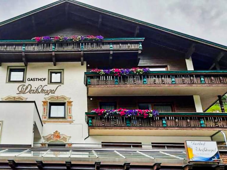 Außenansicht des Gasthof Weißkugel in Vent mit bunten Blumenbalkonen und typischer Tiroler Architektur.