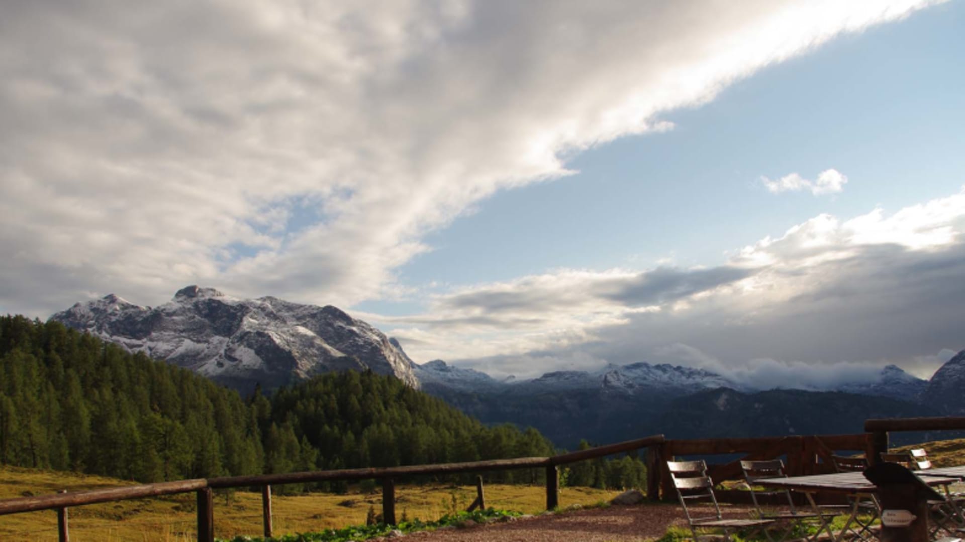 Herbstliche Almlandschaft von der Gotzenalm aus mit verschneiten Gipfeln im Hintergrund.