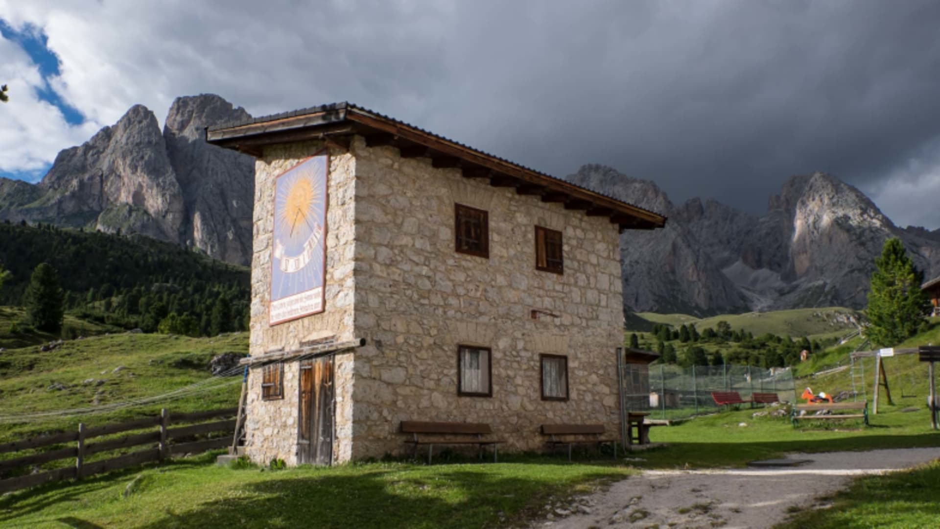 Steingebäude der Regensburgerhütte (Rifugio Firenze) mit traditioneller Sonnenuhr an der Fassade.